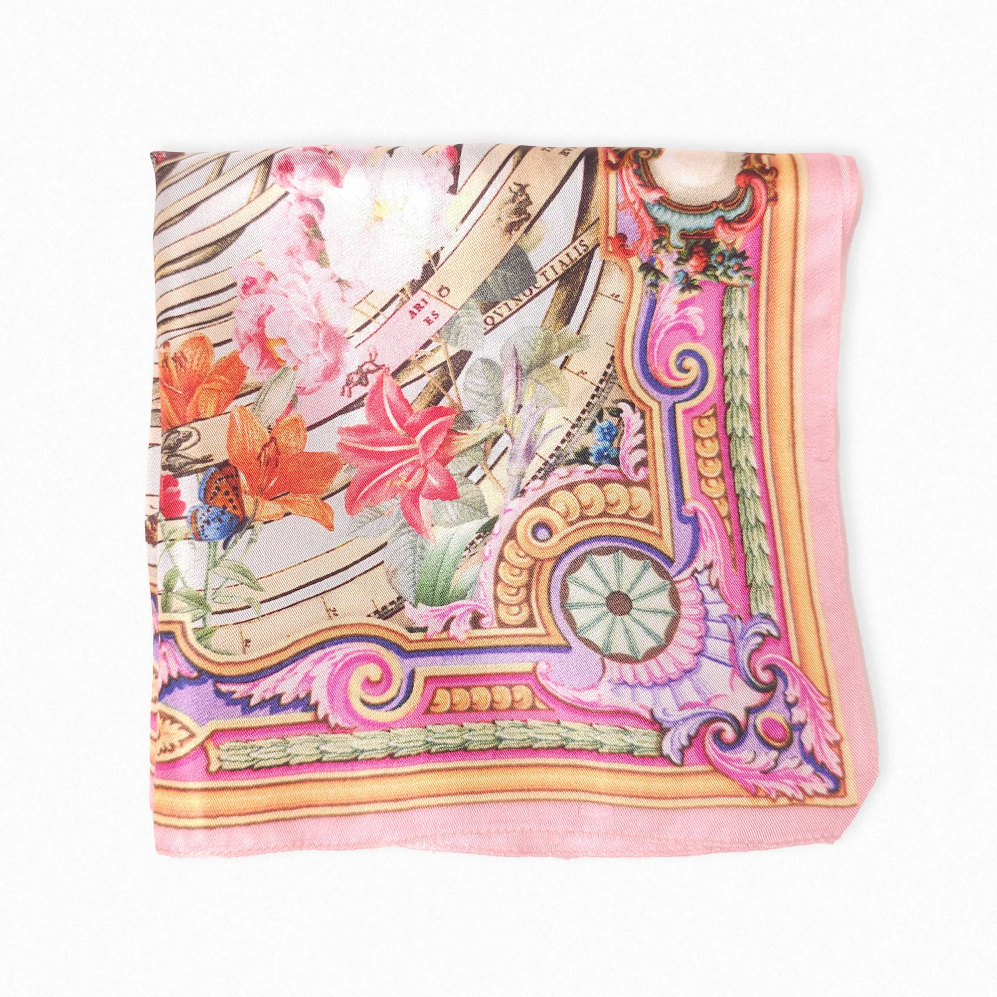 Designer zodiac-themed silk handkerchief – folded styling showing intricate florals, celestial spiral, and ornate border